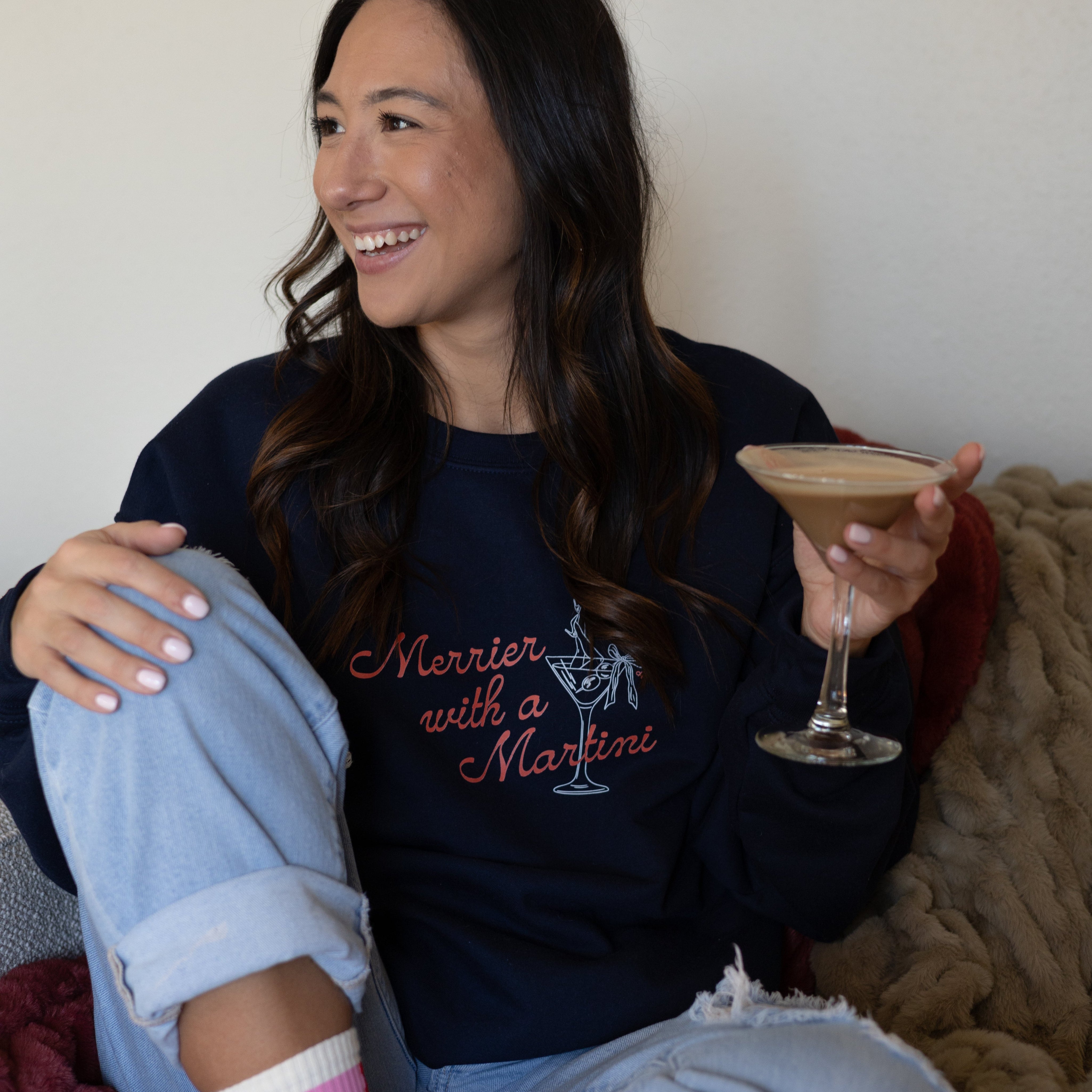 Holiday gifts: model in the Merrier With a Martini crewneck holding a martini
