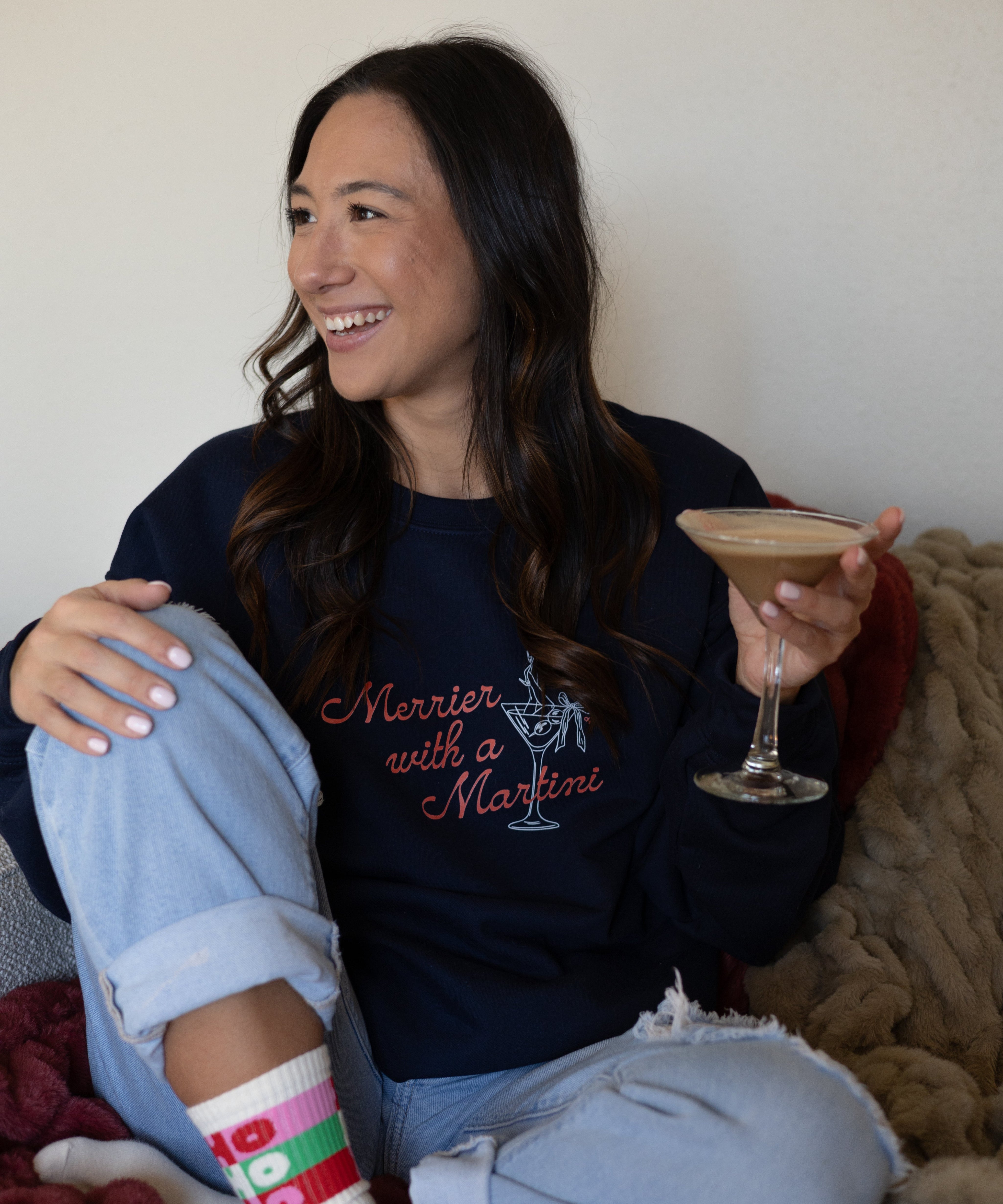 Holiday gifts: model in the Merrier With a Martini crewneck holding a martini