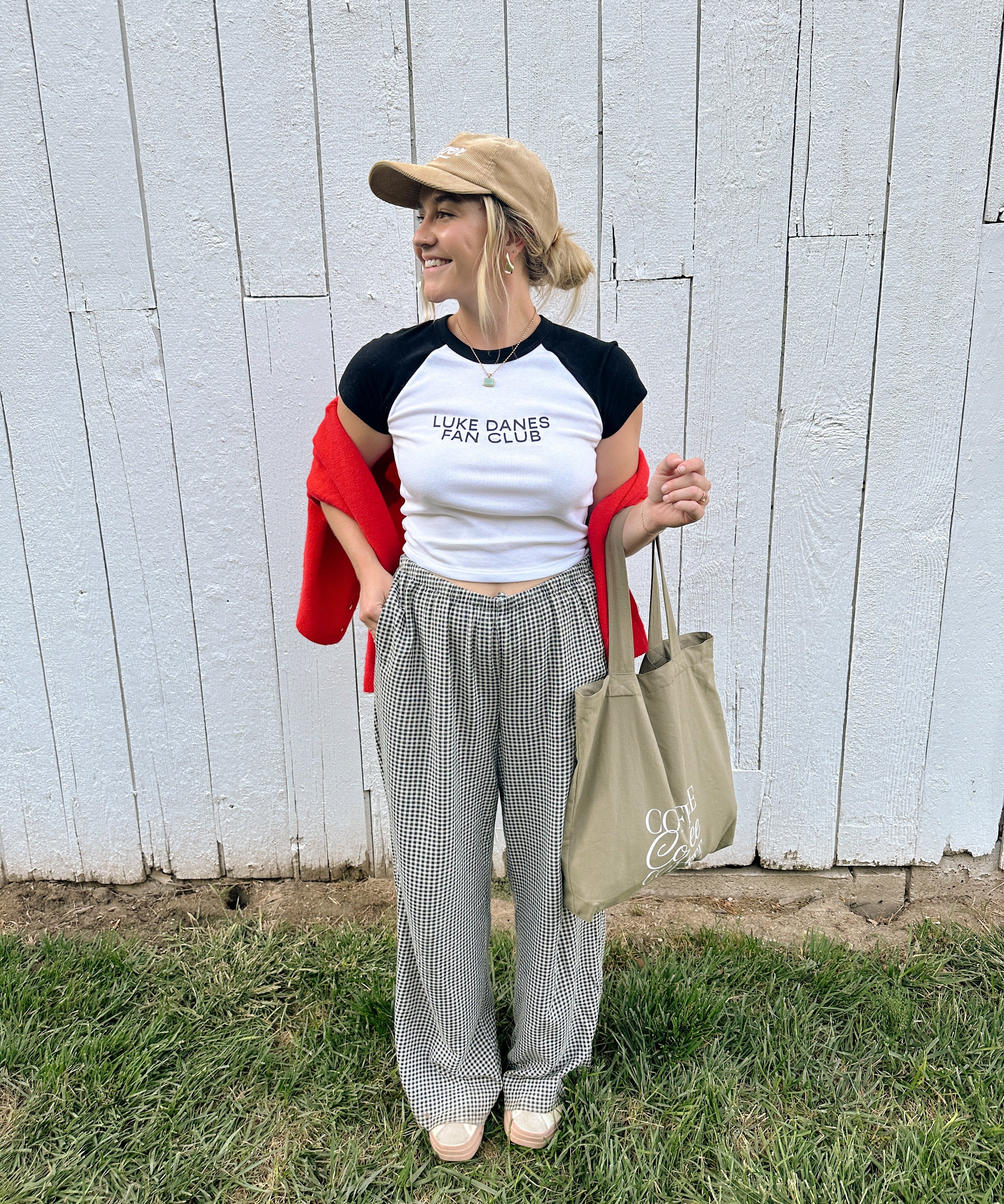 Gilmore Girls merch: model in the Luke Danes Fan Club ribbed tee and cap