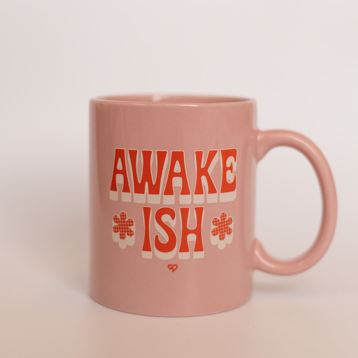Awake *ish* Mug, pink ceramic mug with red lettering reading Awake Ish and checkered flowers