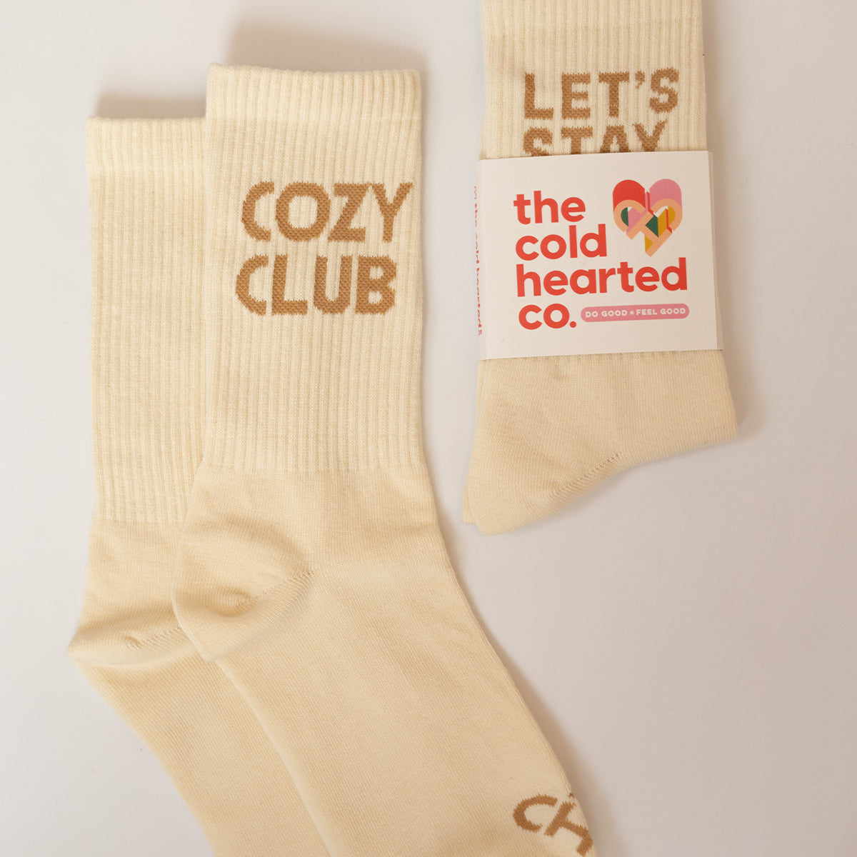 Sock Duo Bundle, cream Cozy Club crew socks beside a banded pair of Let's Stay Home socks from The Cold Hearted Co.