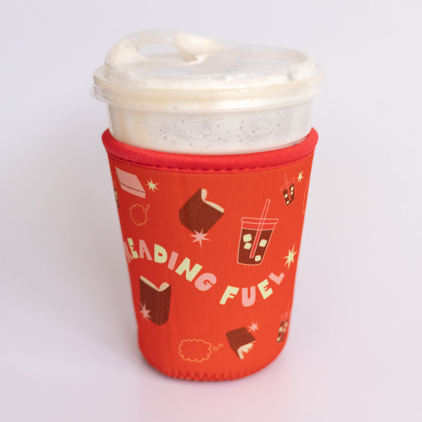 Reading Fuel Coffee Sleeve, red neoprene sleeve with books and iced coffee icons and Reading Fuel text on a cup