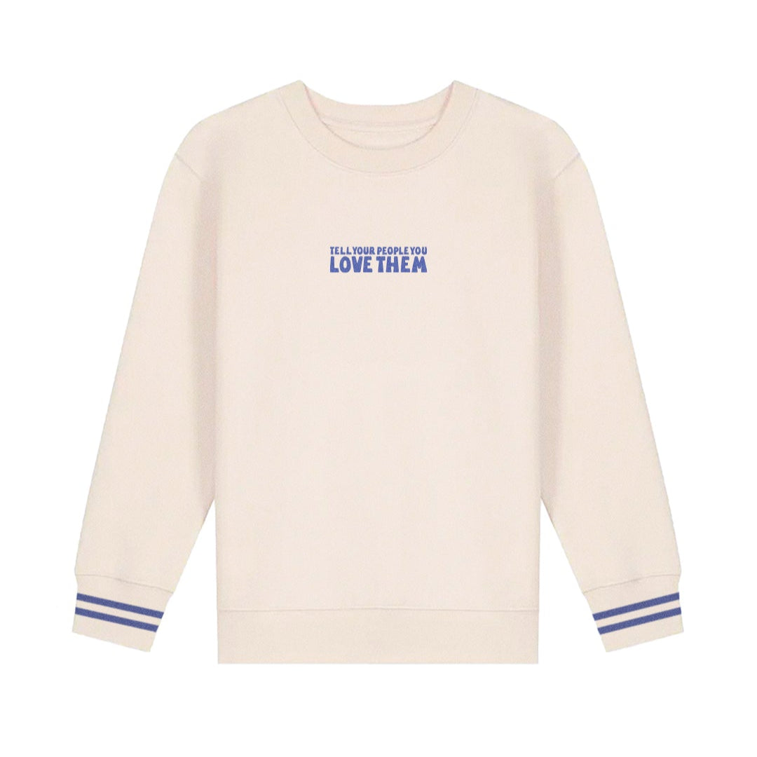 Tell Your People You Love Them Sweatshirt, front of cream crew with small blue chest text and blue striped cuffs