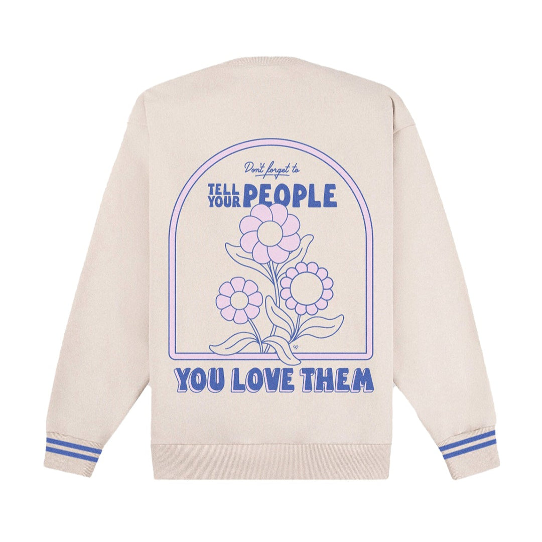 Tell Your People You Love Them Sweatshirt, back of cream crew with blue arch flower graphic and blue striped cuffs