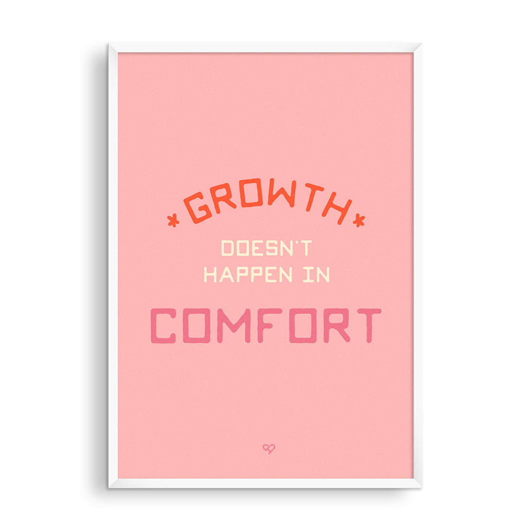 Growth Doesn't Happen in Comfort Print, red and cream lettering on soft pink, in a white frame