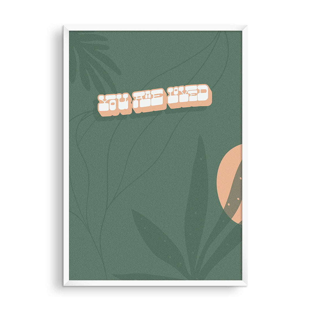 You Are Loved Print, stylized peach 3D lettering on sage green with leaf shapes and a peach circle, framed